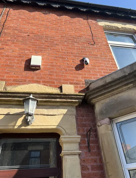 CCTV camera and external lantern fitted to a brick house in Preston