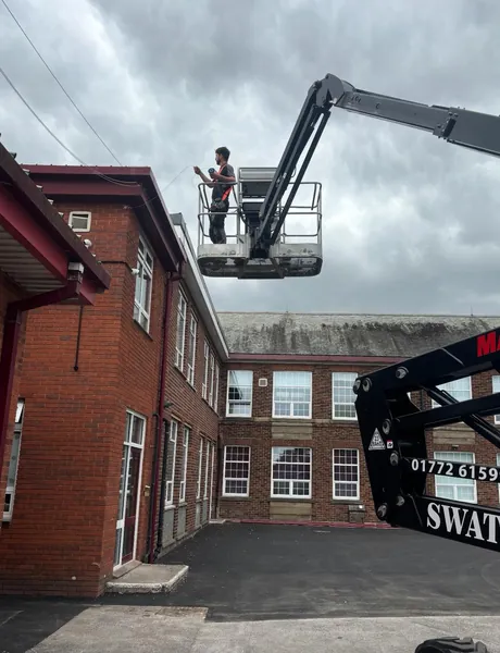 Commercial building external electrical work carried out from an access platform in Preston