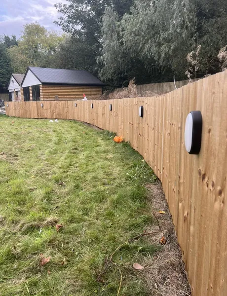 Outdoor bulkhead light fitted to a garden fence in Preston